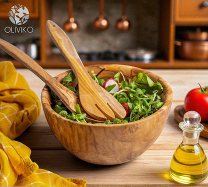 Handcrafted OLIVIKO olive wood bowl with salad and wooden utensils on kitchen counter